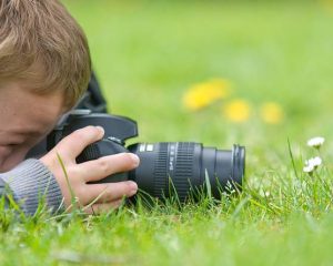 Young boy, nine years old, already practicing with an SLR shooting pictures of nature.